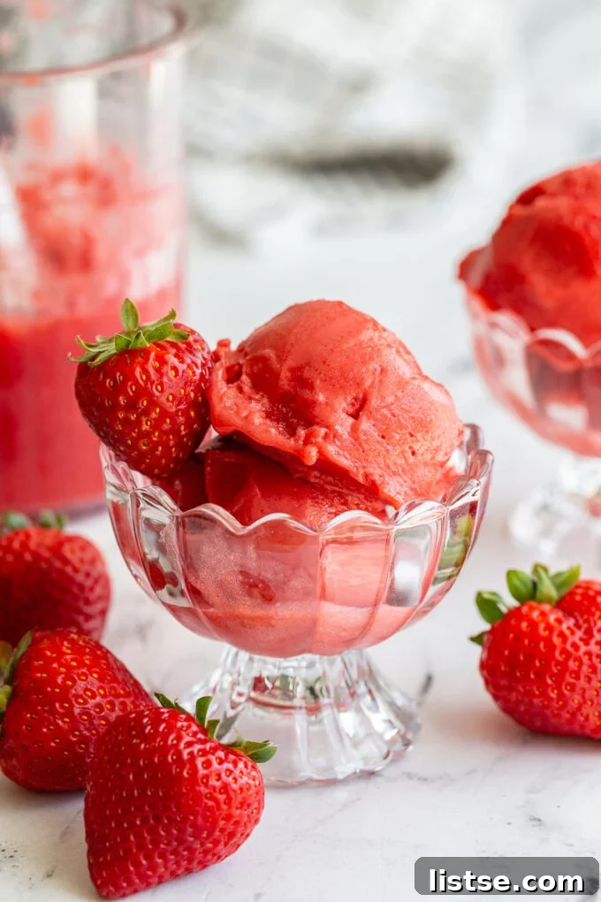 A vibrant bowl of Strawberry Ninja Creami Sorbet, perfectly smooth and glistening, ready to be enjoyed.