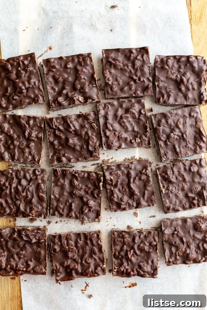 Perfectly cut homemade crunch bars arranged on white parchment paper, ready to be enjoyed.