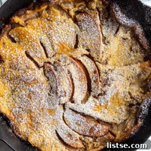 Apple Dutch Baby in a cast iron skillet.