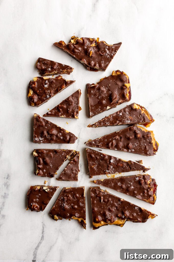 Sheet of freshly made date bark, artfully cut into rough triangular pieces, ready to be enjoyed as a healthy treat.