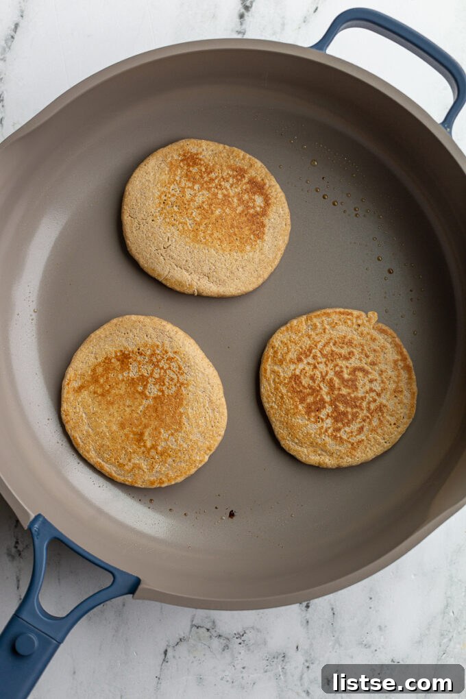 3 browned oat pancakes in a large skillet