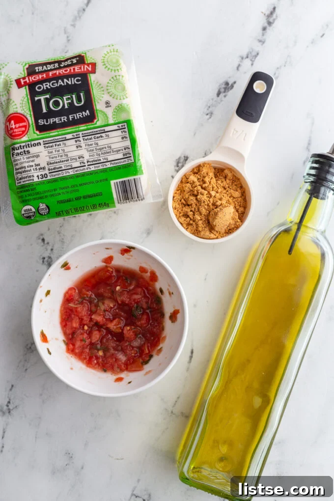 Crispy Tofu Tacos 4 ingredients needed for shredded tofu taco meat including tofu, taco seasoning, salsa, and olive oil