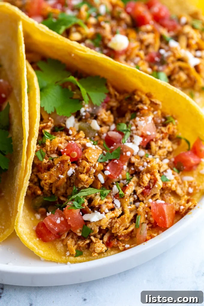 Crispy Tofu Tacos 6 shredded tofu tacos made with corn tortillas and topped with cotija cheese, chopped cilantro, and diced tomatoes