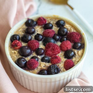 single serve baked protein oats in a ramekin and topped with fruit.