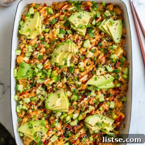 Plant-Powered Sushi Bake 6 vegetarian sushi bake inside of a casserole dish that's topped with heaps of avocado, sesame seeds and drizzled with red sriracha, orange spicy mayo, and kewpie mayo. It's also sprinkled with chopped green onion