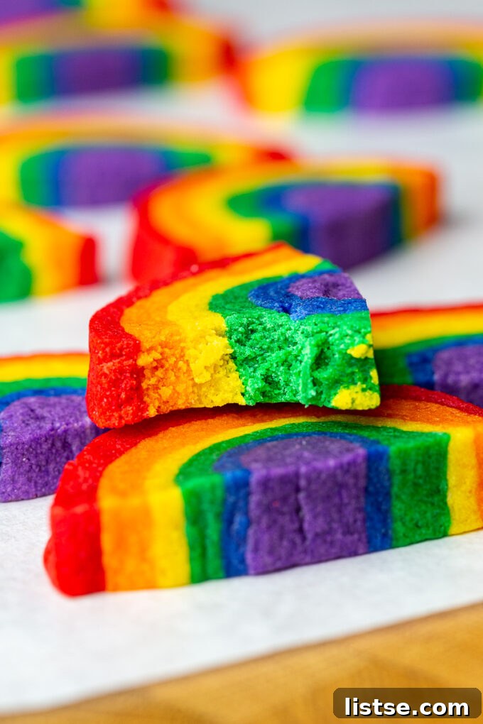 Kaleidoscope Cookies 7 A stack of colorful rainbow cookies on a pristine white plate, ready to be enjoyed.