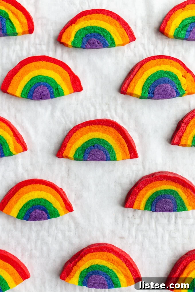 Kaleidoscope Cookies 8 sugar cookies that look like rainbows all lined up on a baking sheet