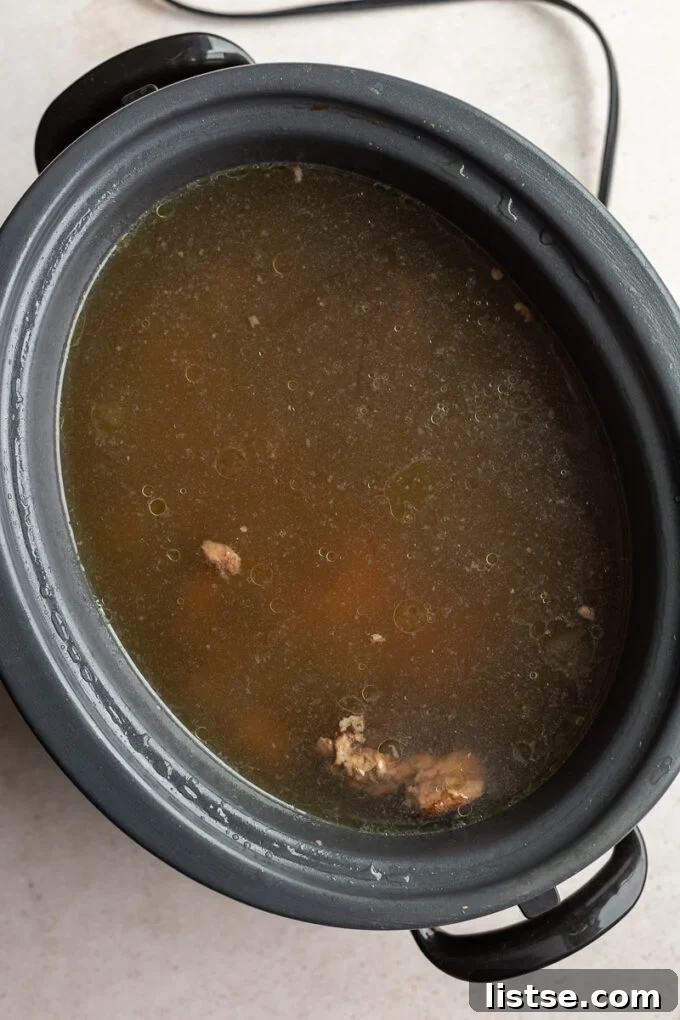 Unlock Canine Wellness with Bone Broth 4 A slow cooker filled with bones, vegetables, and water, ready for making bone broth for dogs.
