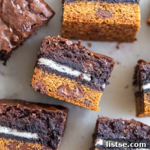 Decadent Layered Brownies 6 A delicious plate of layered Slutty Brownies, displaying the cookie, Oreo, and brownie layers.
