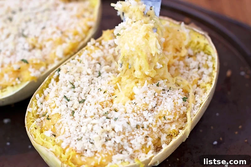 Preparing a spaghetti squash: a sharp knife cutting the squash in half lengthwise for roasting.