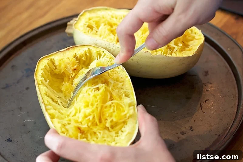 Spaghetti squash strands piled high in a bowl, showing their resemblance to pasta.