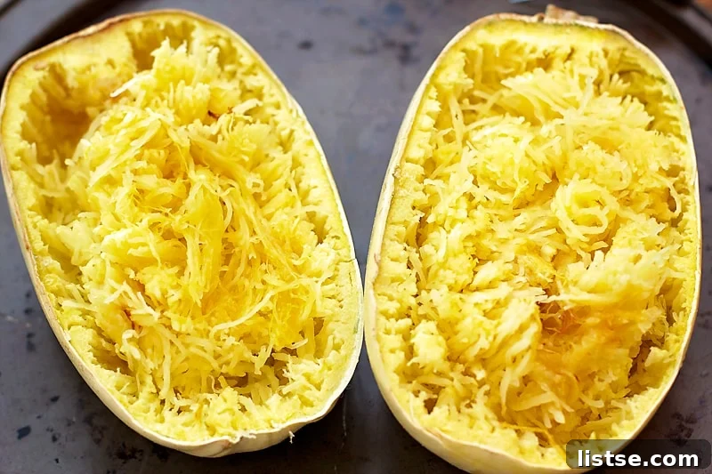 A bowl filled with shredded spaghetti squash, perfectly prepared to be combined with the creamy cheese sauce.
