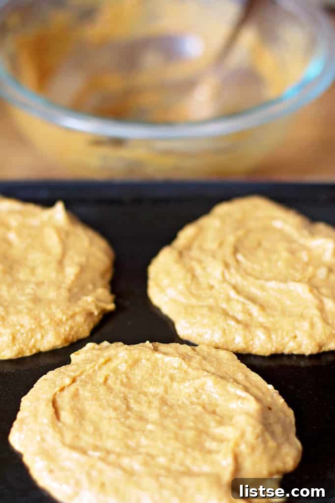 Spiced Pumpkin Protein Stacks 12 Pumpkin Protein Pancake cooking on a skillet