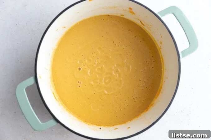 Golden Roasted Cauliflower Velouté 6 A large Dutch oven brimming with the finished orange roasted cauliflower soup, ready to be served