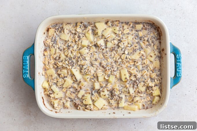 Apple Crumble Baked Oatmeal 4 apple oatmeal in a baking dish before it's been baked, showing a smooth, creamy base
