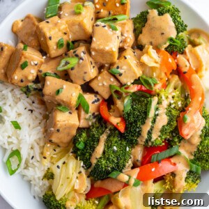 Peanut sauce tofu served with broccoli over rice.