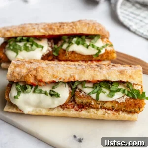 Tofu Parmesan Sandwiches on a marble cutting board.