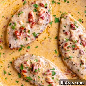 3 pieces of tuscan inspired marry me tofu in a large skillet with lots of creamy sauce in it.