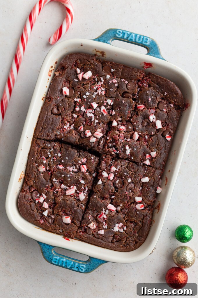 Decadent Mint Chocolate Baked Oats 3 A small casserole dish filled with baked chocolate peppermint oats, garnished with a generous sprinkle of crushed peppermint candy, ready to be served.