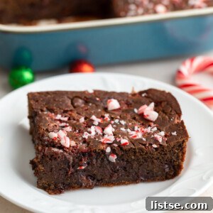 A serving of chocolate peppermint baked oats topped with crushed peppermint on a white plate