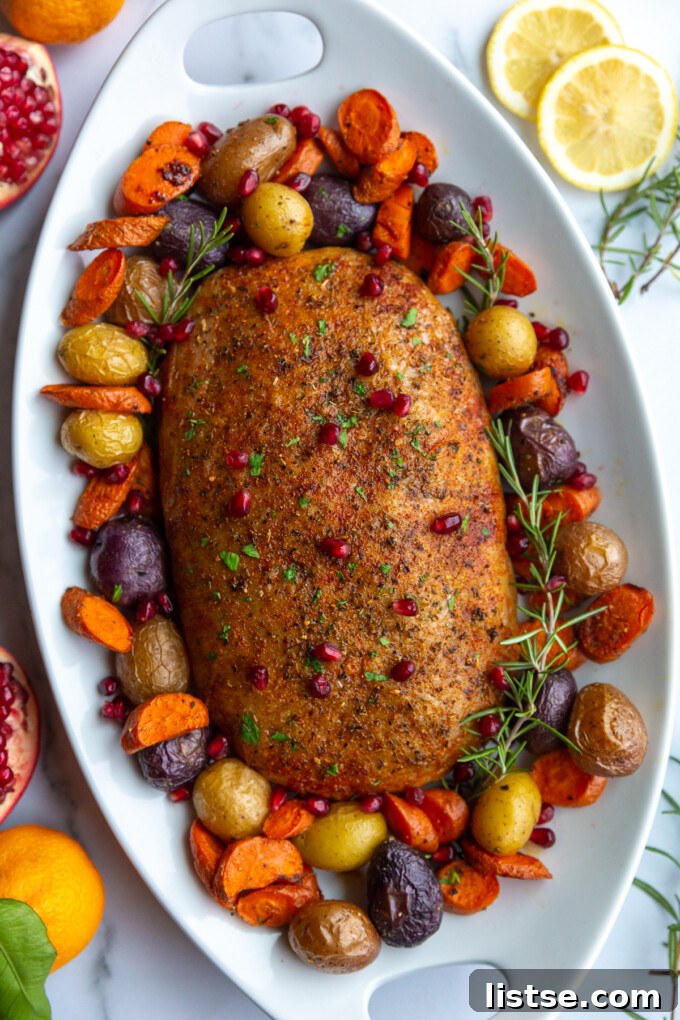 Stuffed Vegan Holiday Roast 2 A stunning stuffed vegan turkey roast, golden brown and surrounded by vibrant roasted vegetables on a festive platter, ready to be served for a holiday meal.