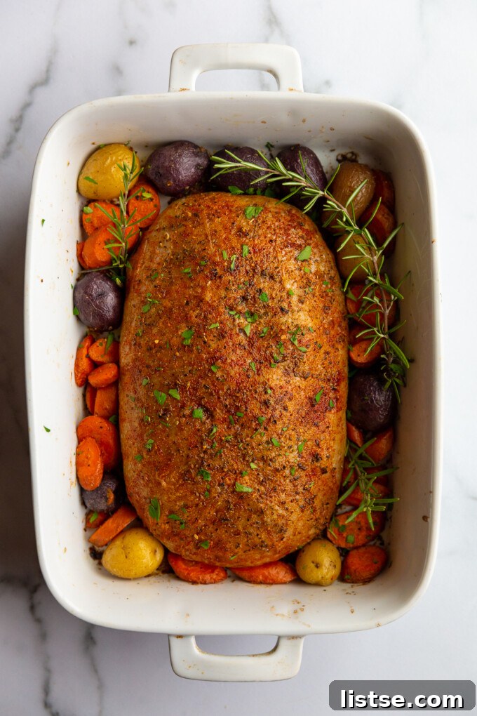 Stuffed Vegan Holiday Roast 3 Close-up of a perfectly roasted stuffed vegan turkey surrounded by festive roasted vegetables, showcasing its crispy exterior and vibrant presentation on a large serving platter.