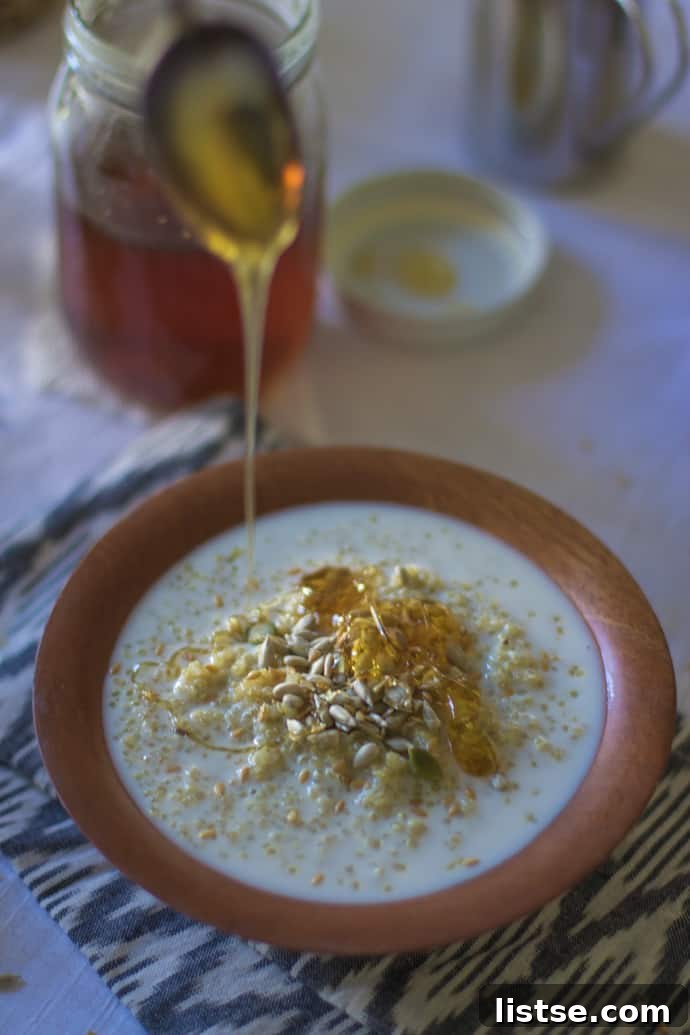 Sprinkling cinnamon on Quinoa Breakfast Cereal Bowl