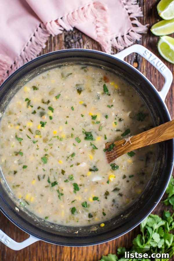 A tempting bowl of White Chicken Chili with a spoon, ready to be enjoyed as a hearty meal.
