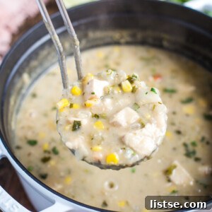 A close-up shot of the creamy White Chicken Chili, generously garnished with fresh herbs and spices.