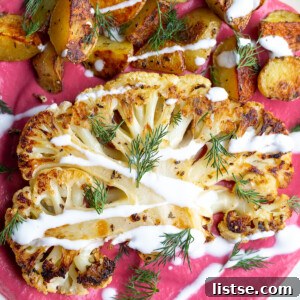 Seared Cauliflower Steaks with Vibrant Beet & Bean Puree 8 roasted cauliflower steak and roasted baby potatoes on a bed of beet been puree and drizzled with yogurt