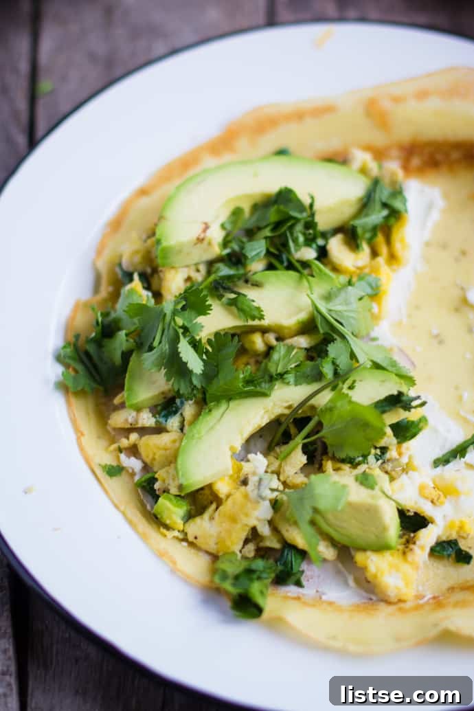 Assembled Savory Breakfast Crepes with egg, avocado, and cilantro