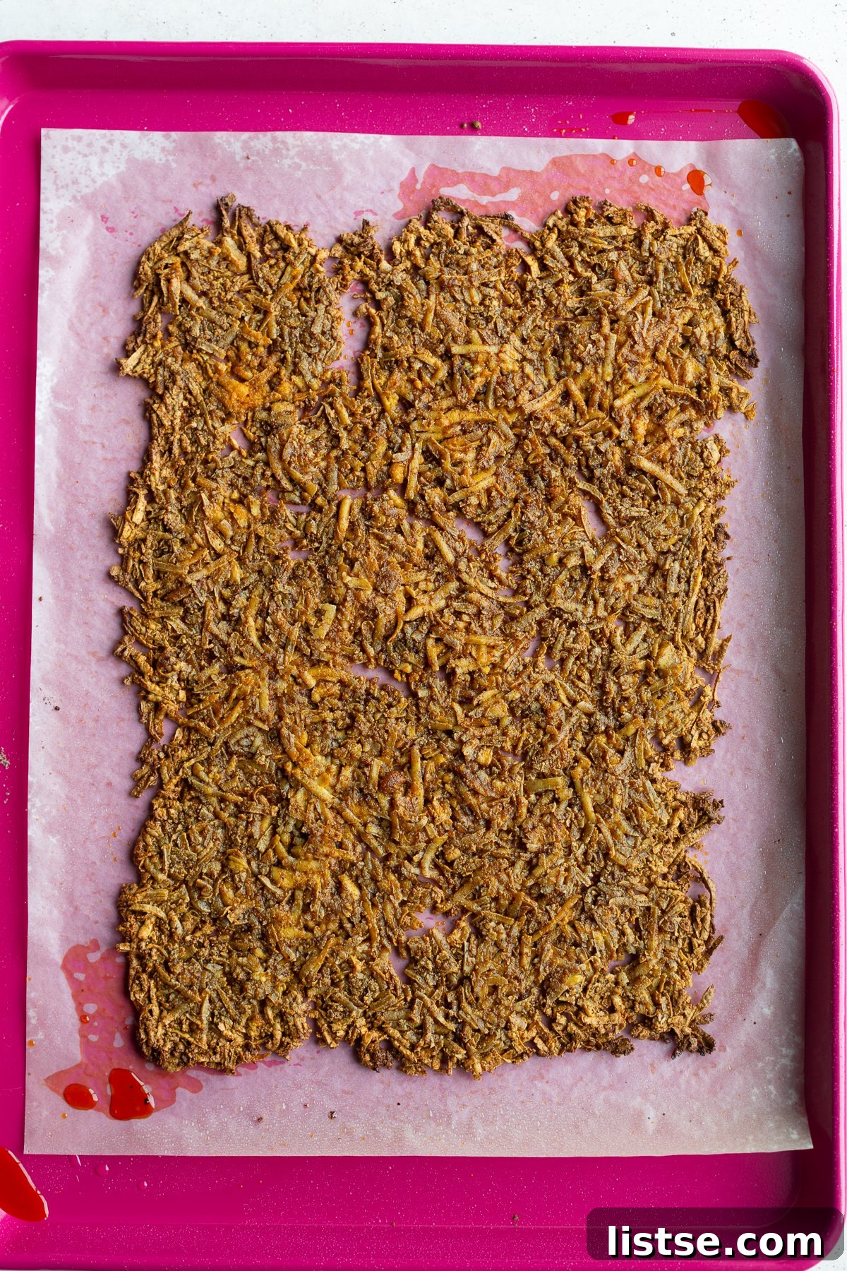 Golden brown baked taco tofu fresh out of the oven, ready for dicing