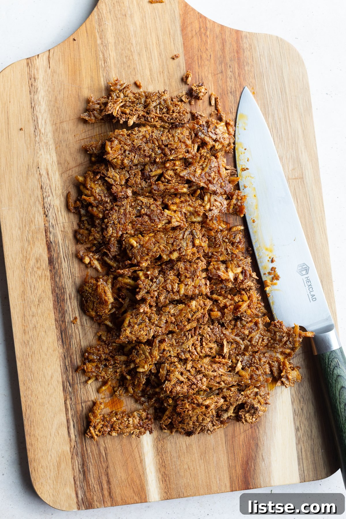 Finely chopped and shredded taco tofu resembling ground meat on a cutting board