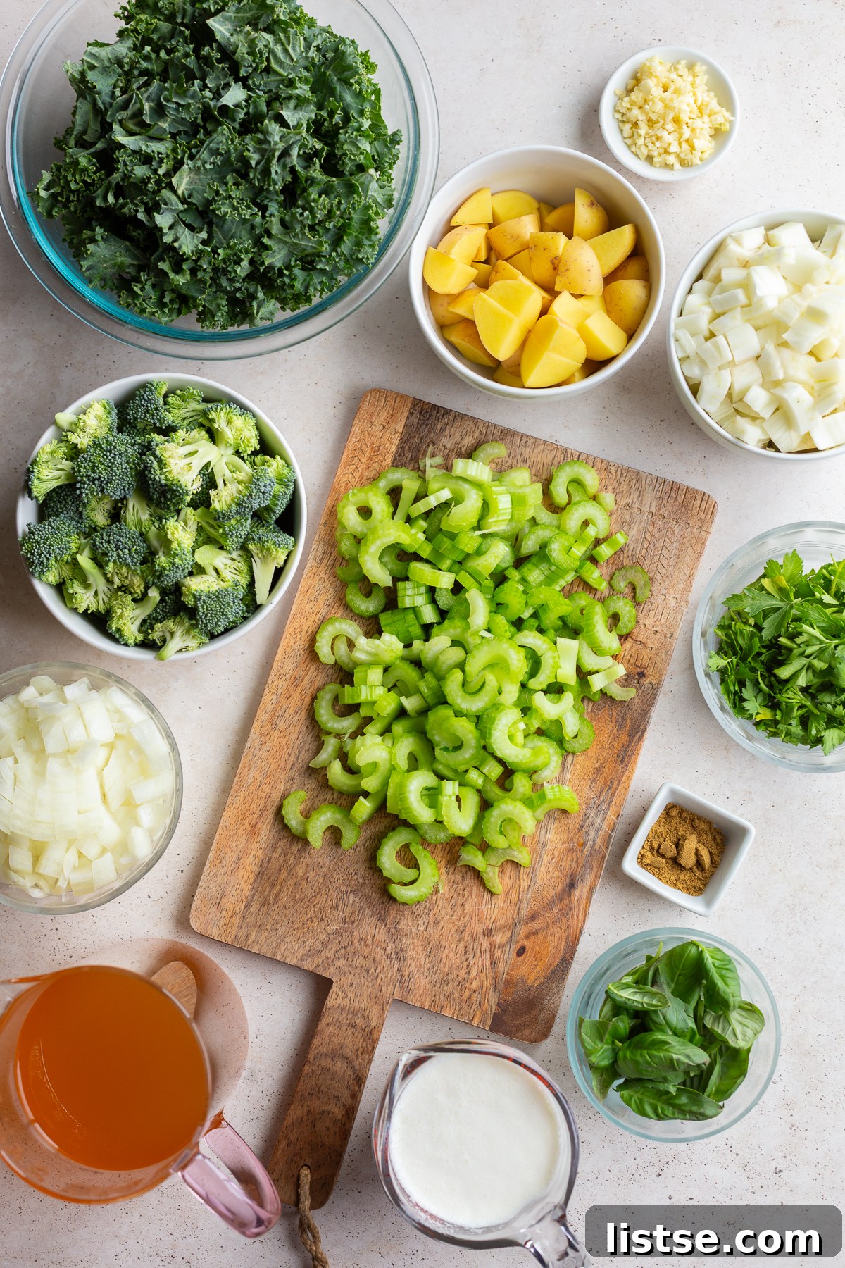 All the fresh ingredients laid out for preparing a vibrant celery Green Goddess Soup.