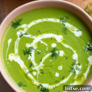 Green Goddess Soup in a pink bowl with a cream drizzle
