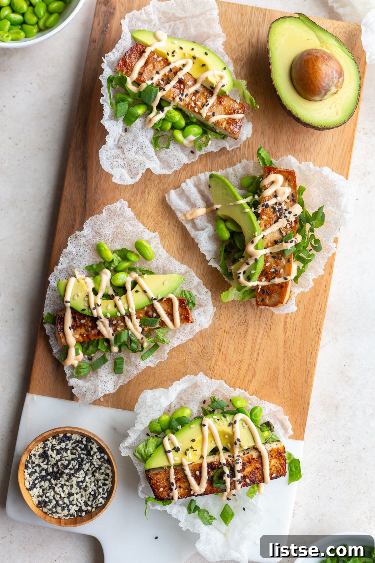Crispy Tofu Rice Paper Tacos 4 A hand holding a rice paper taco, showcasing its crispy texture, filled with delicious toppings.