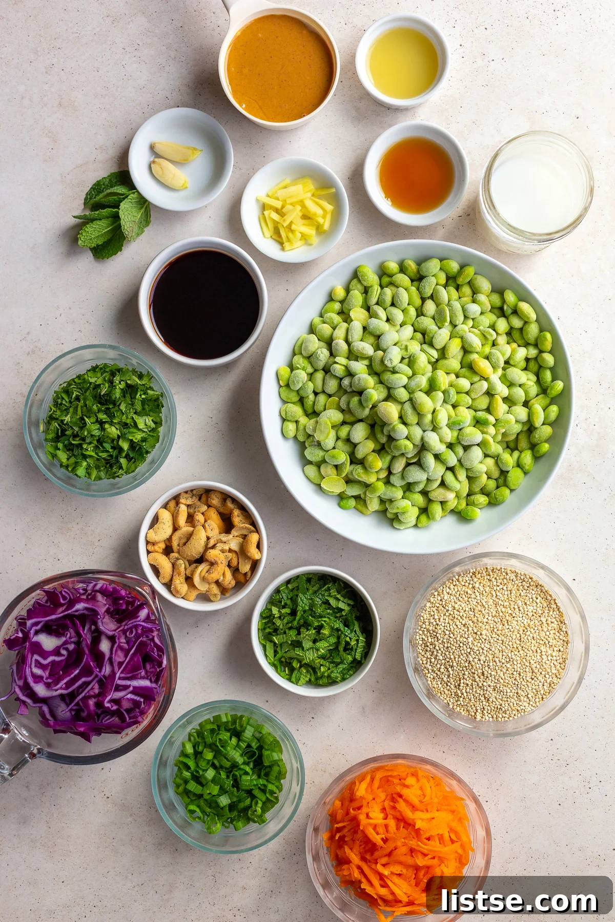 Ingredients for the edamame salad divided into small bowls.
