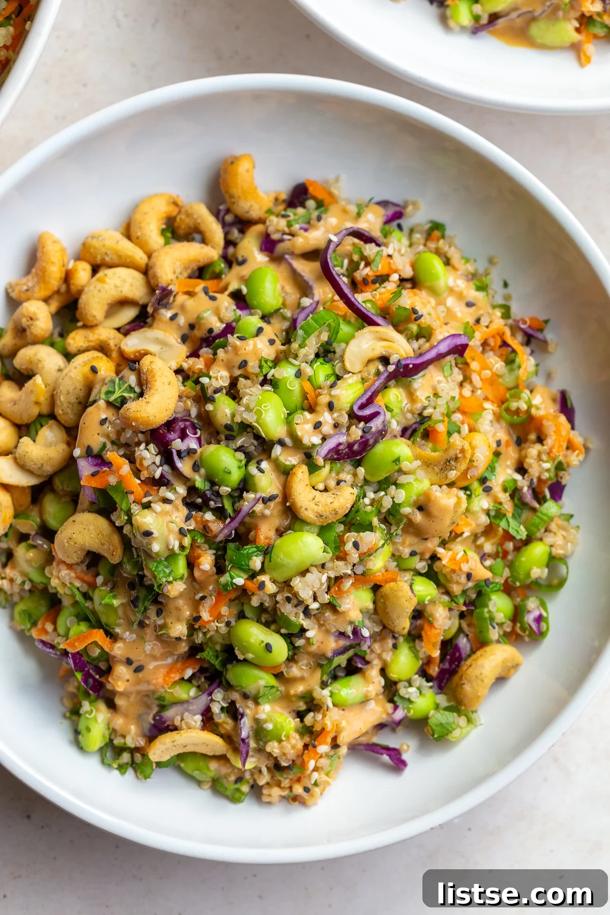 Edamame salad served in a white bowl with cashews.
