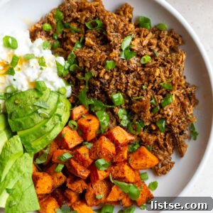 Delicious Tofu Ground 'Beef' Bowl garnished with fresh cilantro and avocado, ready to serve.
