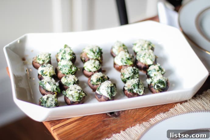 Evening in Bloom 12 Mushrooms filled with a creamy goat cheese and spinach mixture, ready to be baked.