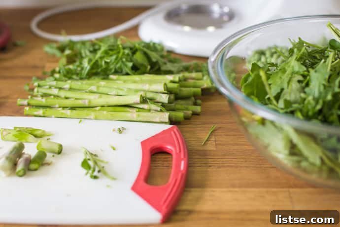 Evening in Bloom 15 Ingredients for the Shaved Asparagus Spring Salad, showcasing fresh greens and ribbons of asparagus.