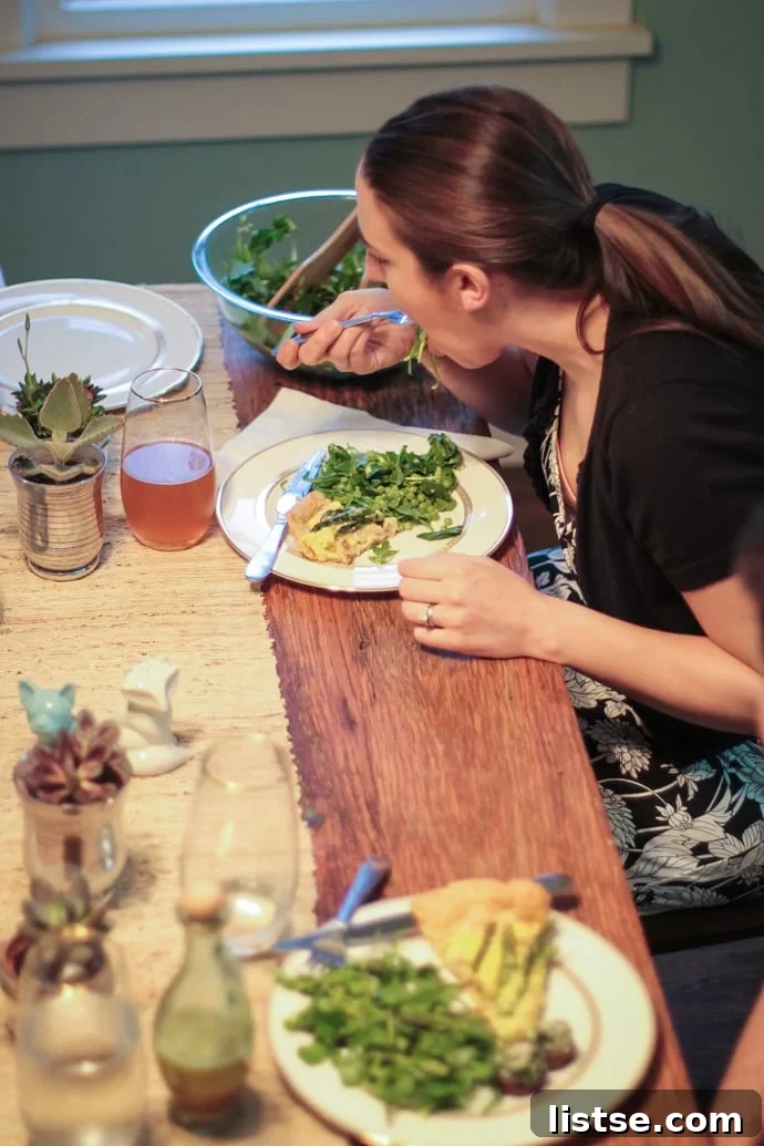 Evening in Bloom 18 The host eagerly enjoying a plate of the delicious Shaved Asparagus Spring Salad, demonstrating its irresistible appeal.
