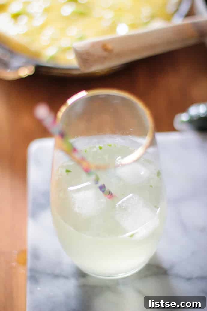 Evening in Bloom 8 A refreshing Elderflower, Basil, and Cucumber Cocktail, garnished beautifully.