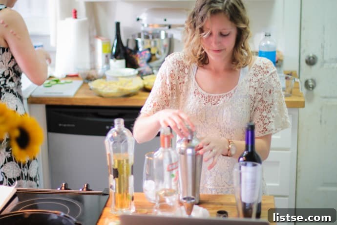 Evening in Bloom 10 Mary, one of the guests, expertly mixing Elderflower, Basil, and Cucumber Cocktails for the party.