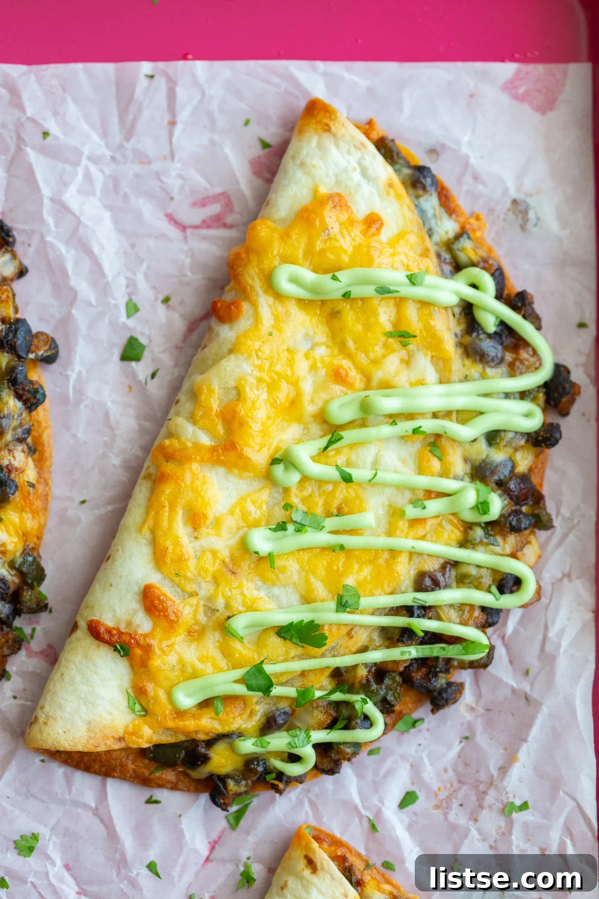 Crispy black bean tacos with perfectly melted cheese on the outside, garnished with fresh cilantro and a savory green sauce.