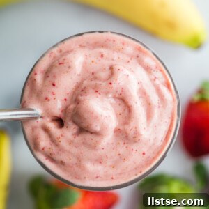 A refreshing strawberry banana smoothie served in a tall glass, indicating a simple yet delicious and healthy start to the day.
