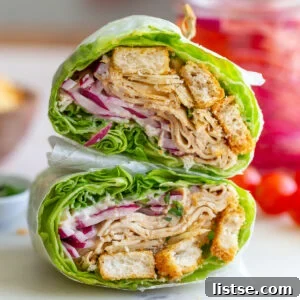 Close-up of a meticulously prepared Caesar Tofu Lettuce Wrap, highlighting the rich fillings.