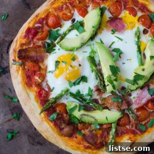 Breakfast pizza with egg, bacon, and herbs.