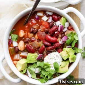 vegan crockpot chili in a white bowl with a spoon