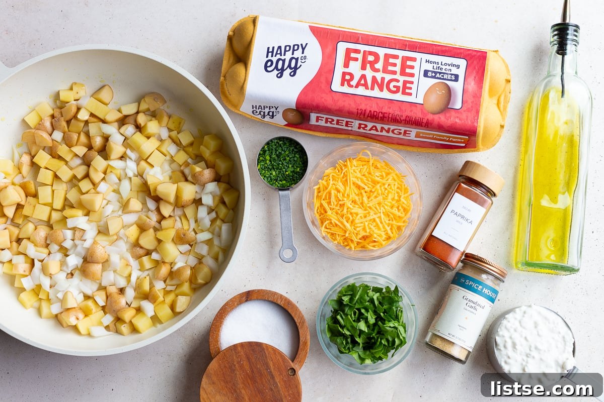 Ingredients laid out for making Starbucks-style potato chive egg bites, including eggs, cheese, potatoes, and chives